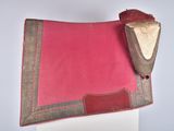 an image of a pink and brown saddle pad on top of a white table