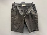 a pair of shorts hanging on a hanger on a wall