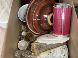 a cardboard box filled with assorted items on the floor