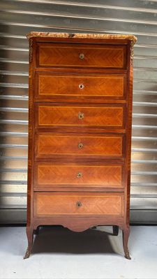 an antique chest of drawers with a marble top on a stand