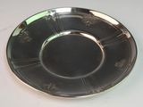 a silver plate on a white table with a white background