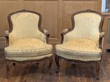 two chairs sitting next to each other on a wooden floor