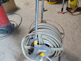 a hose on the floor next to a fire hydrant in a garage