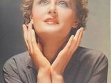 an old photo of a woman with her hands on her face