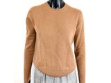 a mannequin mannequin wearing a tan sweater and plaid pants