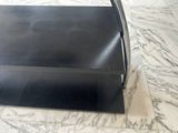 a black metal shelf with a black handle on a marble floor
