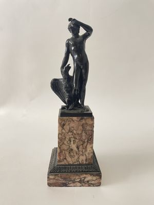 an image of a statue of a woman standing on a marble base