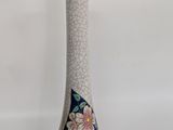 a white vase with a blue and white design on it