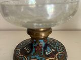 a close up of a glass bowl on a stand on a table