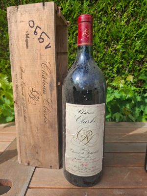 two bottles of wine sitting on a table next to a wooden box