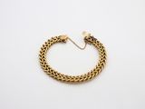 an image of a gold bracelet on a white background