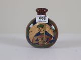 a small vase with a picture of a man on it