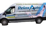 the van is parked on the side of the road with the words relax auto written on it