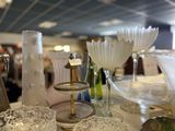 many glass vases and plates on the table
