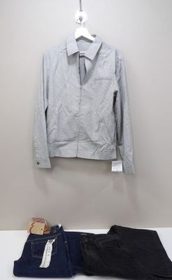 a shirt and jeans on a hanger next to a pair of jeans