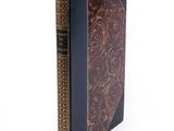 an old book with a leather cover on a white background
