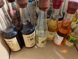 many bottles of alcohol sitting on a table
