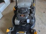 an image of a lawn mower sitting in a garage