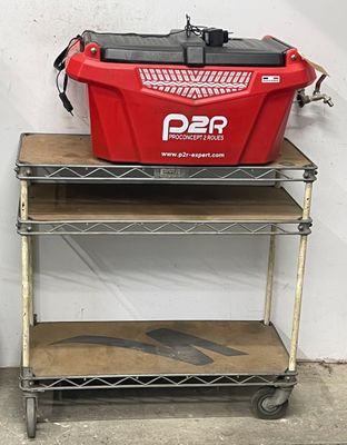 a red cooler sitting on top of a metal cart