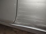 a close up of a car ' s paint job on the side of the car