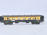 a blue and yellow train car that is on a white surface