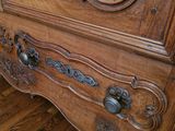 a wooden cabinet with a mirror on top of it