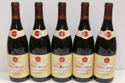 six bottles of wine are lined up on a table
