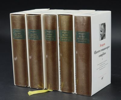 three books are stacked on top of each other on a black surface