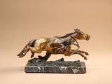 bronze statue of a horse and rider on a marble base