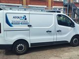 a white van that is parked in front of a building