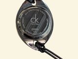 a close up of a wrist watch on a cord