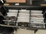 a drawer that has glasses and other items in it