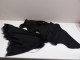 a black dress that is laying on a white table