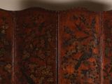 an old wooden screen with birds and flowers on it