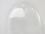 underside view of a clear glass dome on a white surface