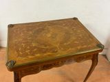 a small table with a wooden top on a tile floor