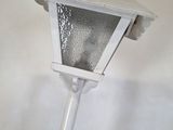a white light that is on a pole in the room