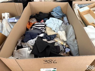 a cardboard box filled with clothes and other items