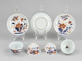 a group of porcelain dishes and cups sitting on a table