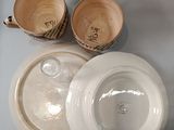 three bowls and two cups sitting on a table