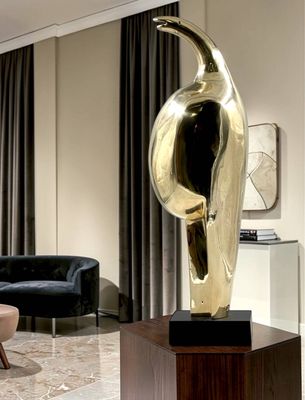 a statue of a bird on a pedestal in a living room