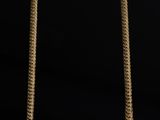 a gold necklace on a black background