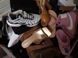 a suitcase full of shoes and bags on the floor