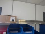 two bins that are sitting on the shelf in the room