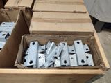 several boxes of metal parts are stacked on top of each other