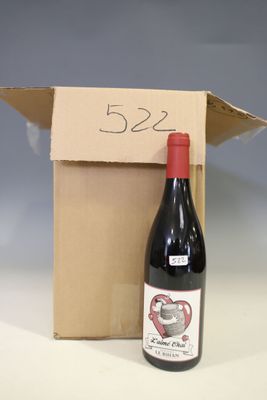 a bottle of wine sitting next to a cardboard box