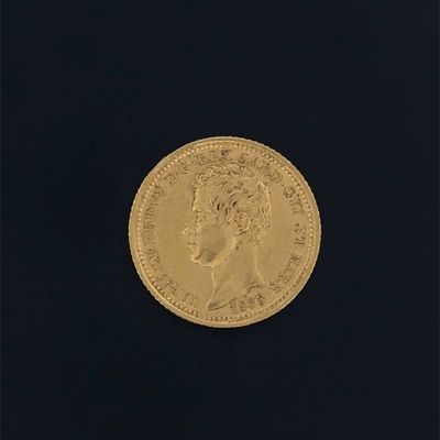 a close up of a gold coin on a black background