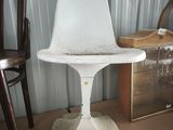 a white chair that is sitting on top of a table