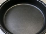 a black pan sitting on top of a white counter