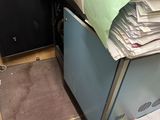 a pile of papers sitting on top of a filing cabinet